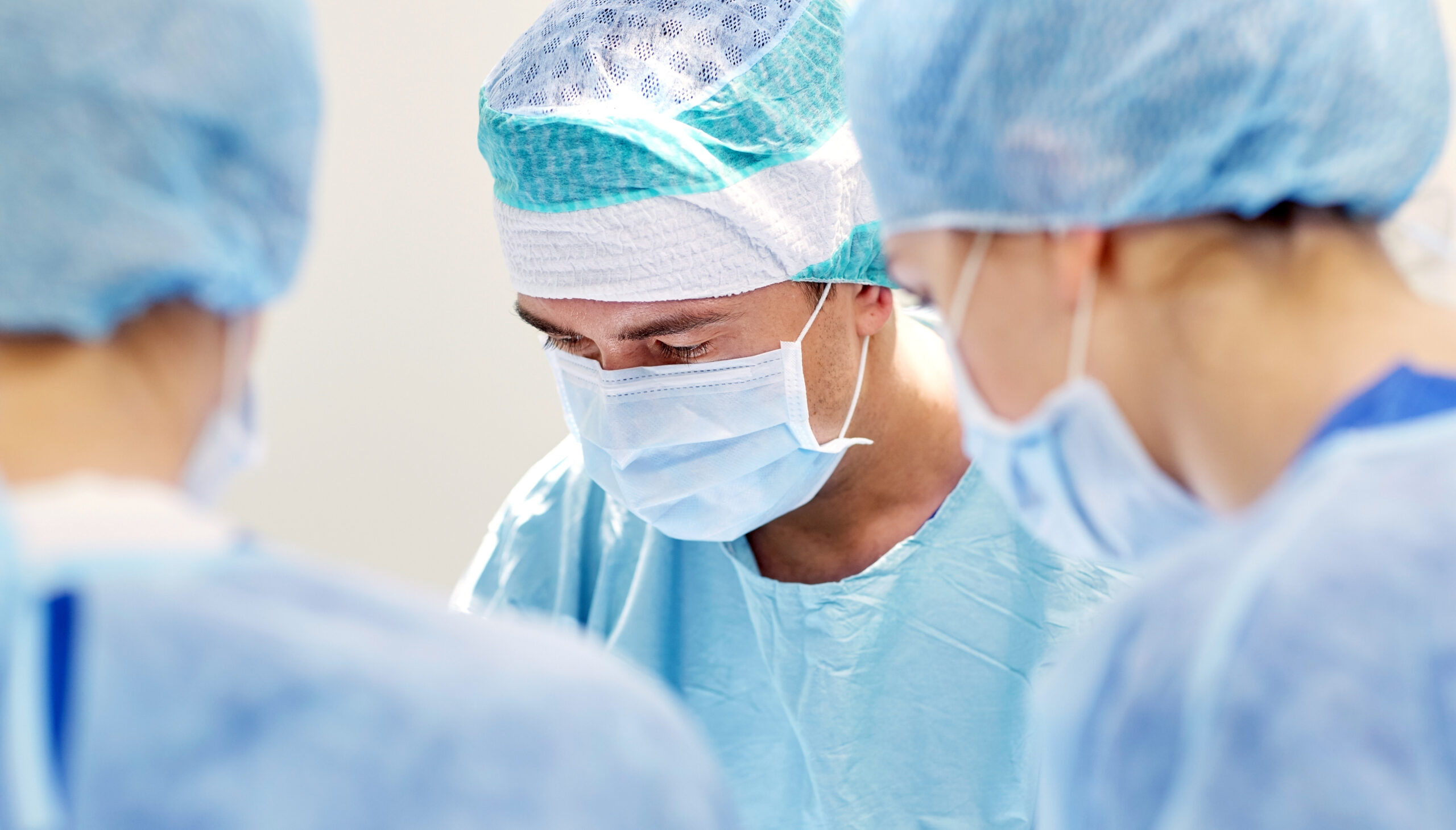 Group Of Surgeons In Operating Room At Hospital