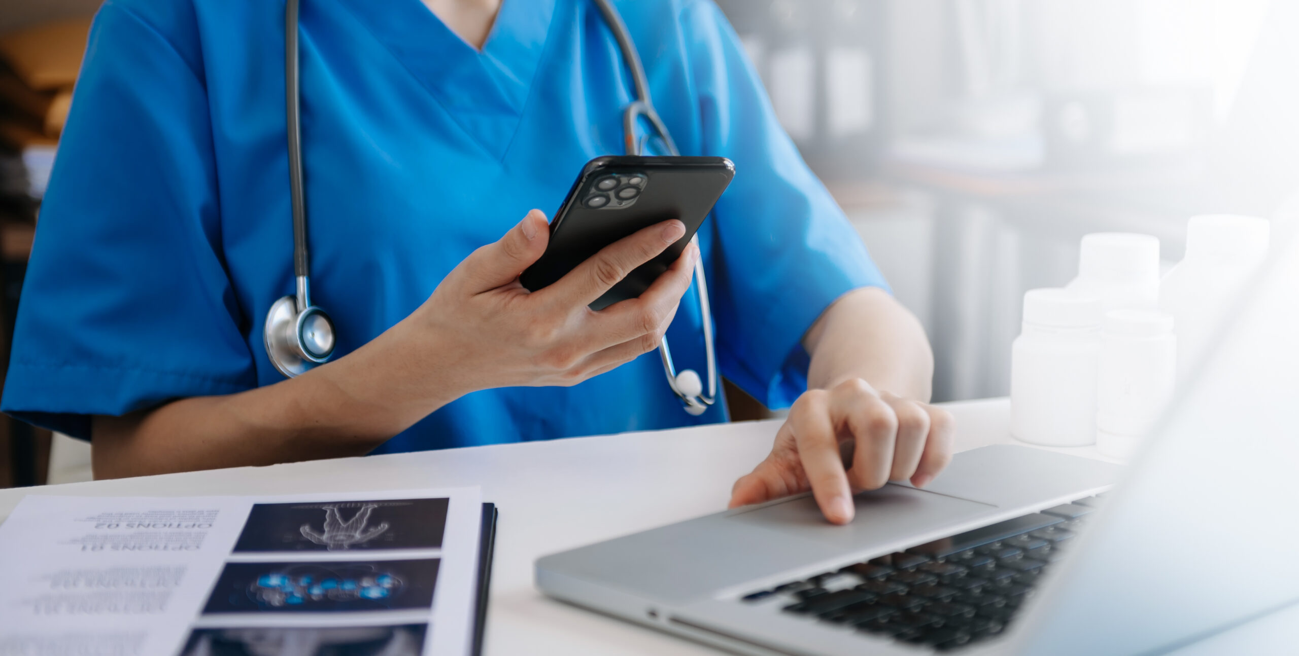 Cropped Shot Of Young Female Doctor Summarises Patient Charts With Digital Tablet In Her Office Room.